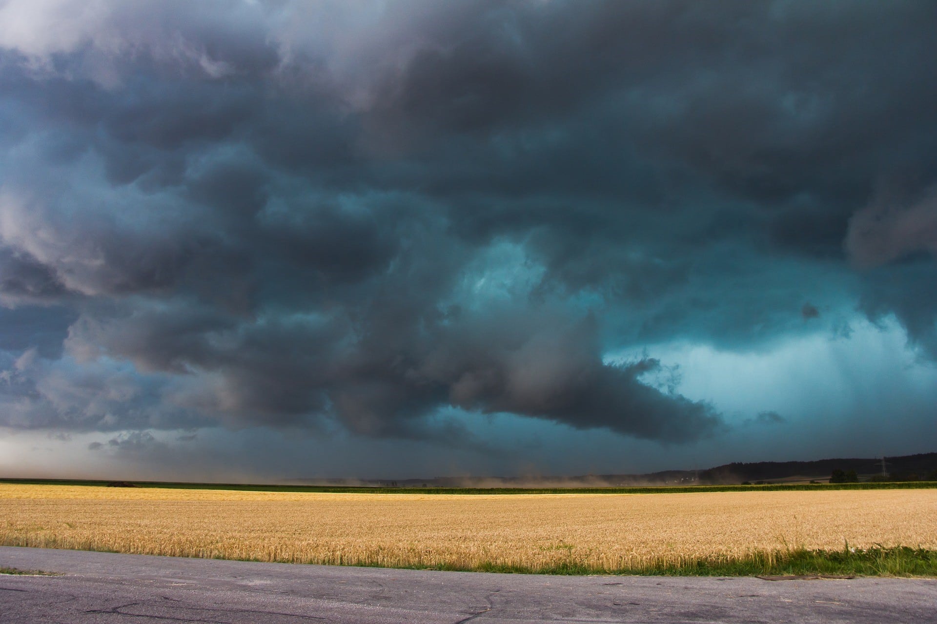 Stormy sky over a wheat field. Dark clouds suggest the need for business roller shutters. Weather protection for your business.